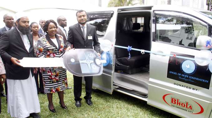 First Lady Auxillia Mnangagwa receives a symbolic key for a vehicle donated to her charity organisation Angel of Hope by Bhola Hardware directors Anis and Anif Patel at Zimbabwe House yesterday. — Picture by John Manzongo