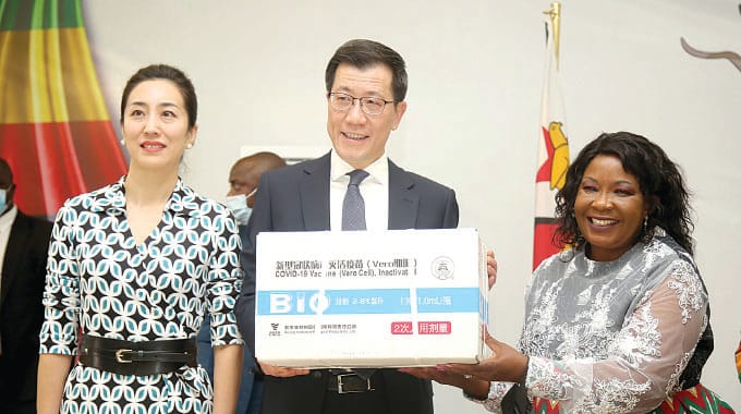 First Lady Dr Auxillia Mnangagwa receives a consignment of Sinopharm doses from the Ambassador of China to Zimbabwe Guo Shaochun (centre) while his wife, Wang Wei, looks on during the handover ceremony at State House in Harare yesterday