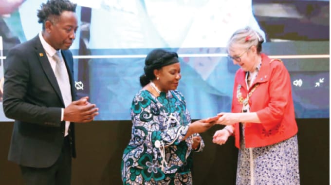 First Lady Dr Auxillia Mnangagwa receives a Global Education Leadership Award from Cambridge International Education Conference for her outstanding contribution to education and women empowerment which was presented by the Mayor of Cambridge Jenny Gawthrope Wood, while former mayor of Corby Clr Tafadzwa Chikoto looks on