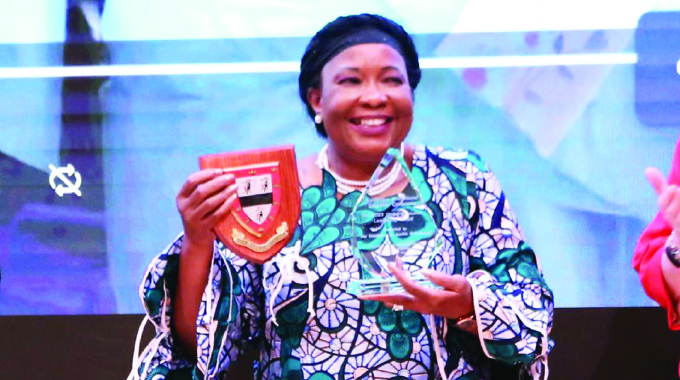First Lady Dr Auxillia Mnangagwa displays her Global Education Leadership Award presented to her in recognition of her outstanding contribution to education, women and the girl child empowerment