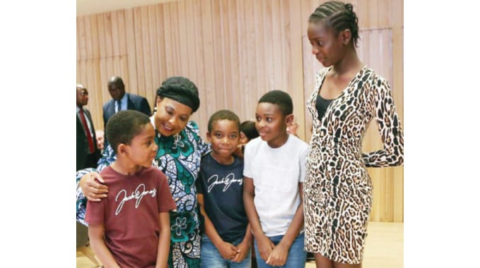 First Lady Dr Auxillia Mnangagwa chats with Zimbabwean children studying at Millfield Primary School who came to see her