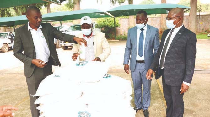 Ministry of Health and Childcare representative Dr Stephen Banda (right) receives scouring powder donated to the Ministry by Angel of Hope Foundation patron First Lady Dr Auxillia Mnangagwa while Zimbabwe Integrated Traders Association representatives explain the packaging in Harare yesterday