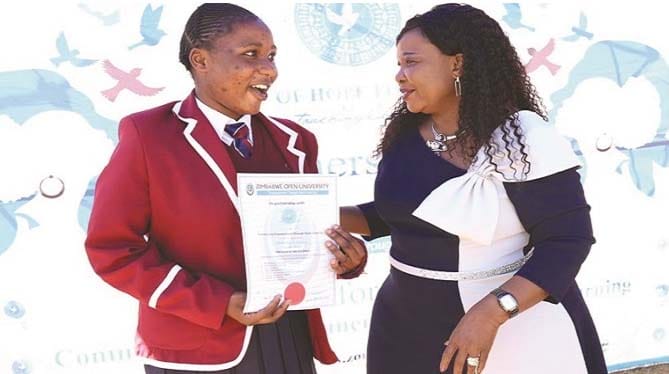 First Lady Dr Auxillia Mnangagwa congratulates Kerina Parirenyatwa, an Upper Six learner at Mutoko High School, who studied Nurse Aid and Palliative Care for the elderly during the graduation of beneficiaries of the Angel of Hope Foundation and ZOU short courses partnership in Marondera yesterday