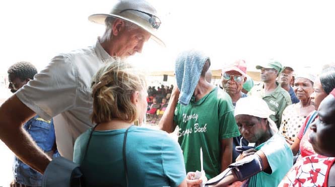 Angel of Hope Foundation partners from the US, Mrs Roz Peterson and her husband Mr Guy Peterson, check the blood pressure of patients during a free medical outreach organised by First Lady Dr Auxillia Mnangagwa in Kanyemba recently.