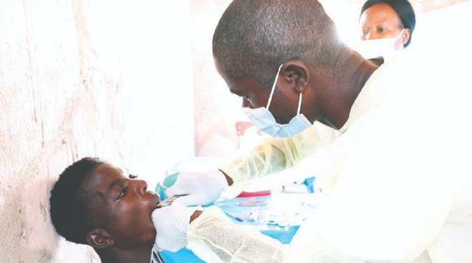 Dentists attend to patients during a Angel of Hope Foundation free medical outreach organised by Health and Child Care Ambassador First Lady Dr Auxillia Mnangagwa in Kanyemba recently. — Pictures: John Manzongo