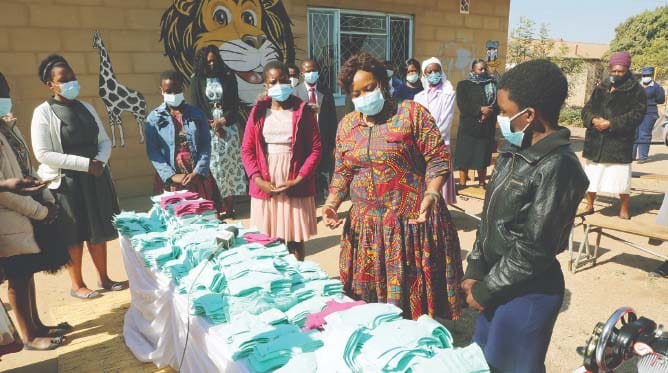 First Lady Auxillia Mnangagwa interacts with girls trained by Angel of Hope Foundation to make reusable sanitary wear which they are distributing to their disadvantaged peers thereby ensuring that girls do not skip school lessons because of lack of sanitary wear