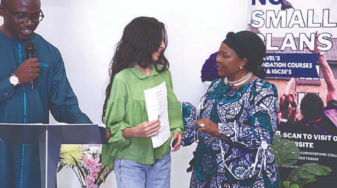 First Lady Dr Auxillia Mnangagwa presents a certificate to one of the students who completed her studies at the Cornerstone College Cambridge while director of the college, Mr David Ogunbode looks on