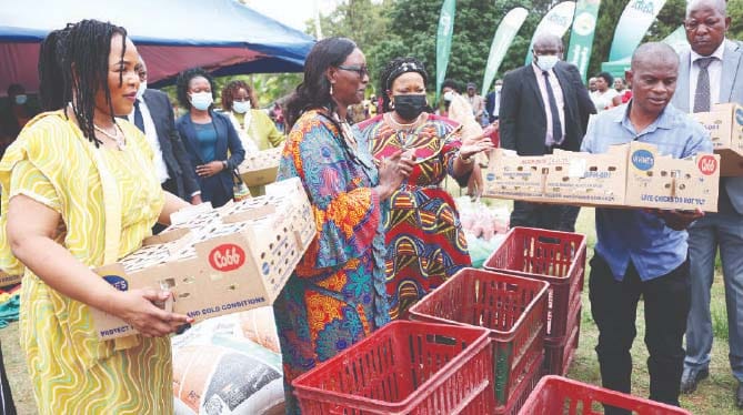 Spouses of African Ambassadors accredited to Zimbabwe, Mrs Chifundo Polepole from Malawi and Mrs Umutesi Katushabe Julian from Rwanda, hand over day old chicks donated by Angel of Hope Foundation to beneficiaries, while First Lady Dr Auxillia Mnangagwa, who is patron of Agriculture-for-She, look on after the launch of Urban Transformation Programme in Dzivaresekwa, Harare on Monday