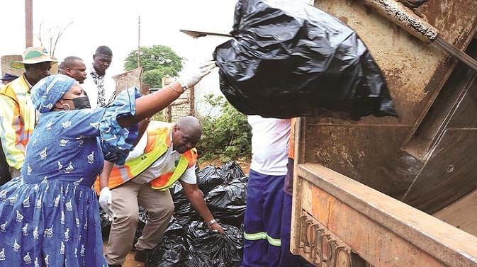 Environment and wildlife patron Dr Auxillia Mnangagwa throws litter into a refuse collection truck during the national clean-up campaign in Chegutu yesterday