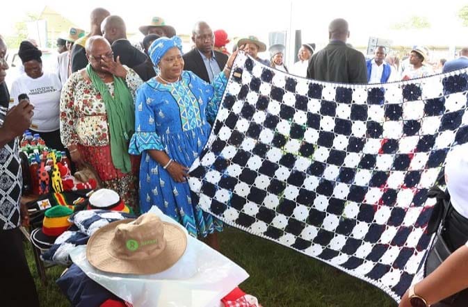 First Lady Dr Auxillia Mnangagwa looks at the various types of showels, blankets, dresses, handbags and other items designed by women who are part of the widows association she formed in Mashonaland West. — Pictures: John Manzongo