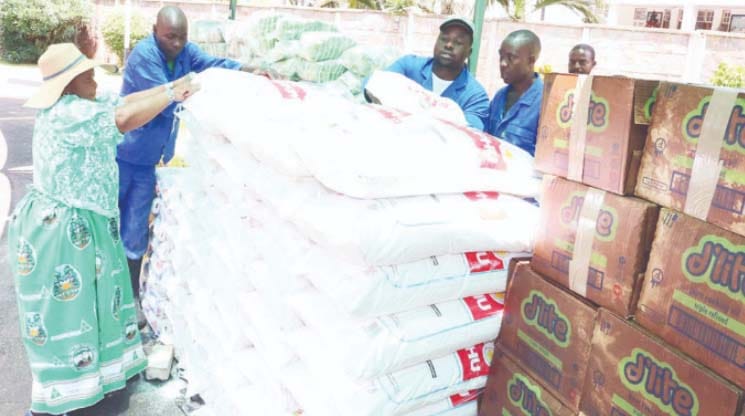 Angel of Hope Foundation patron and founder First Lady Dr Auxillia Mnangagwa and staff from her office pack food hampers for distribution to homes and prisons across the country at Zimbabwe House yesterday