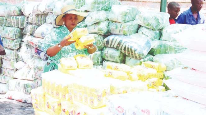 First Lady Dr Auxillia Mnangagwa packs Christmas food hampers for distribution to homes and prisons across the country at Zimbabwe House yesterday