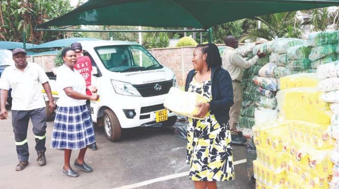 Mrs Kumbirai Tipedze of Harare Children’s Home and representatives from other homes load Christmas food hampers they received from Angel of Hope Foundation patron First Lady Dr Auxillia Mnangagwa into their trucks at Zimbabwe House yesterday. – Pictures: John Manzongo