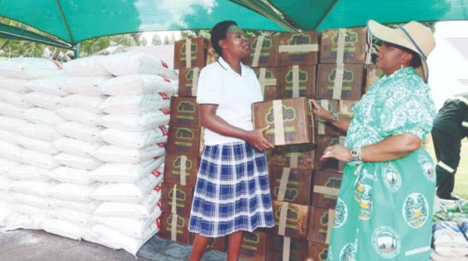 First Lady Dr Auxillia Mnangagwa hands over Christmas food hampers to Ms Evidence Tembo of Philadelphia Children’s Home at Zimbabwe House yesterday