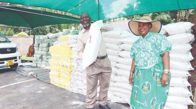 Angel of Hope Foundation patron and founder First Lady Dr Auxillia Mnangagwa hands over food hampers to Mr Bright Masenda of Philadelphia Children’s Home at Zimbabwe House yesterday