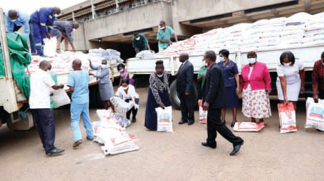 Medical staff from Parirenyatwa Group of Hospitals, Sally Mugabe and Chitungwiza Central Hospitals offload mealie-meal and rice donated by Health Ambassador, First Lady Dr Auxillia Mnangagwa (Pictures by John Manzongo and Obey Sibanda)