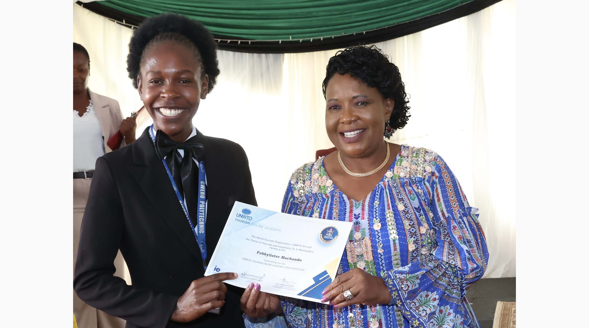 Patron of Tourism and Hospitality First Lady Dr Auxillia Mnangagwa hands over a scholarship from United Nations Tourism 