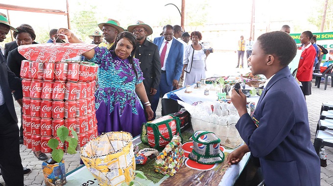 First Lady Dr Auxillia Mnangagwa marvels at a laundry basket made from recycled cans by learners, during the national Clean Schools Competition awards ceremony in Masvingo