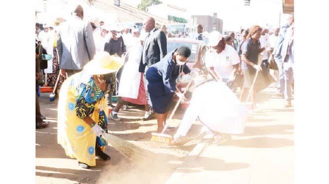 First Lady Dr Auxillia Mnangagwa leads in a clean-up campaign in the Harare Central Business District yesterday.