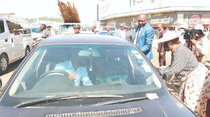 First Lady Dr Auxillia Mnangagwa talks to motorists about the importance of not throwing litter through car windows during a clean-up campaign in Harare’s Central Business District yesterday