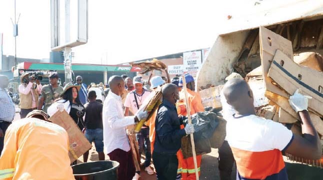 People load litter into a refuse truck during a clean-up campaign which was led by Environment and Tourism patron First Lady Dr Auxillia Mnangagwa in Harare’s Central Business District yesterday