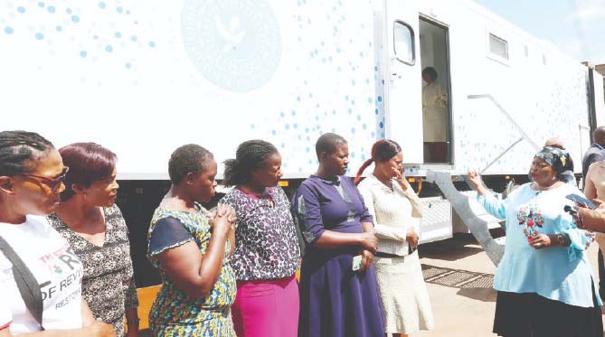 Angel of Hope Foundation patron First Lady Dr Auxillia Mnangagwa teaches women awaiting breast cancer screening from her ultra-modern top notch mobile hospital, the importance and benefits of being screened for cancer at Parirenyatwa Group of Hospitals yesterday