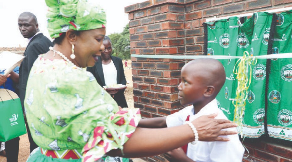 First Lady Dr Auxillia Mnangagwa interacts with St Alban primary school learner Judith Mupamanga after she had recited a poem on environment conservation during the quadruple commemoration of international environmental days in Buhera District, Manicaland province