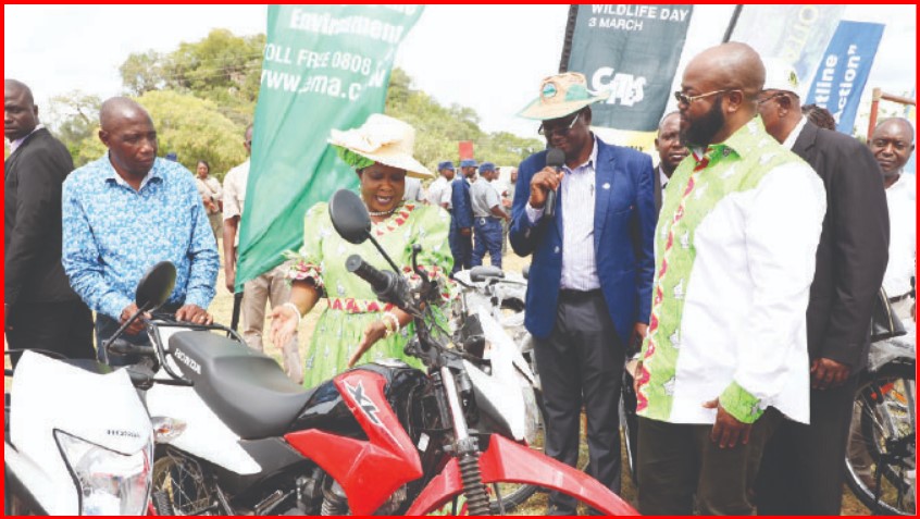 Environment Patron and wildlife Ambassador Dr Auxillia Mnangagwa hands over motorbikes to Manicaland Minister of State for Provincial Affairs and Devolution Advocate Misheck Mugadza (right) for him to distribute to the beneficiaries in Buhera yesterday. — Pictures: Innocent Makawa