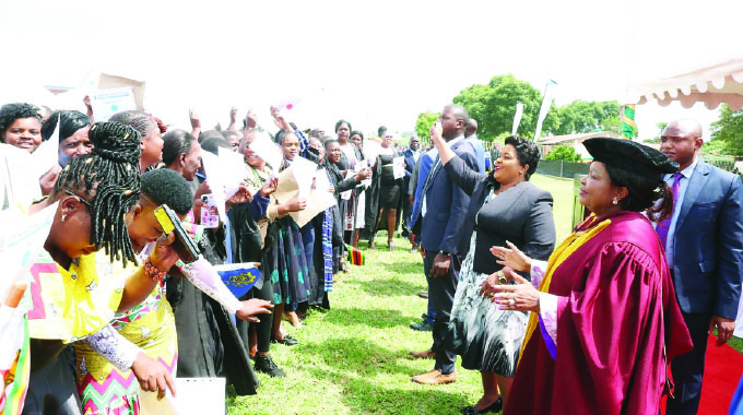 First Lady Dr Auxillia Mnangagwa joins on the dance floor beneficiaries of her Angel of Hope Foundation partnership in short courses with ZOU as they celebrate their achievements at ZRP Staff College in Harare yesterday. — Pictures: John Manzongo