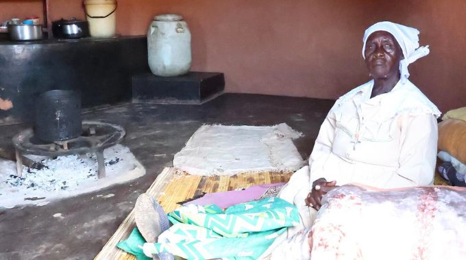 Gogo Jane Zindoga with her blankets and hampers she received from First Lady Dr Auxillia Mnangagwa in Mutasa, Manicaland yesterday