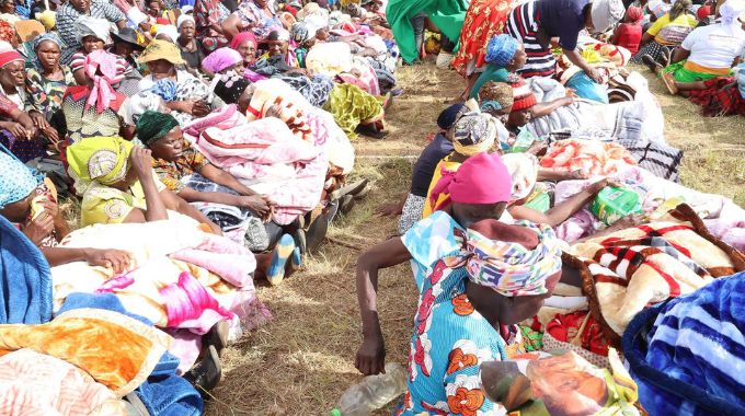 Beneficiaries with the goods they received from First Lady Dr Auxillia Mnangagwa in Mutasa, Manicaland yesterday