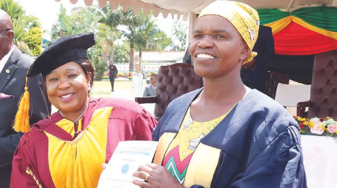 First Lady Dr Auxillia Mnangagwa congratulates one of the beneficiaries of her Angel of Hope Foundation partnership in short courses with Zimbabwe Open University at ZRP Staff College in Harare yesterday.