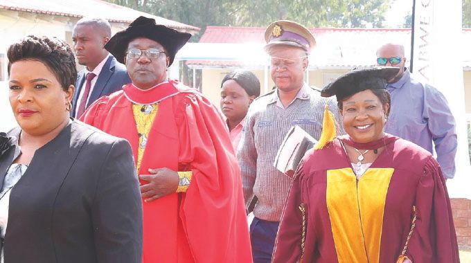 Angel of Hope Foundation patron First Lady Dr Auxillia Mnangagwa, Deputy Minister of Home Affairs and Cultural Heritage Chido Sanyatwe and Zimbabwe Open University Vice Chancellor Professor Paul Gundani in the academic procession during the graduation of beneficiaries of Angel of Hope Foundation and ZOU partnership in short courses at the Zimbabwe Republic Police Staff College yesterday