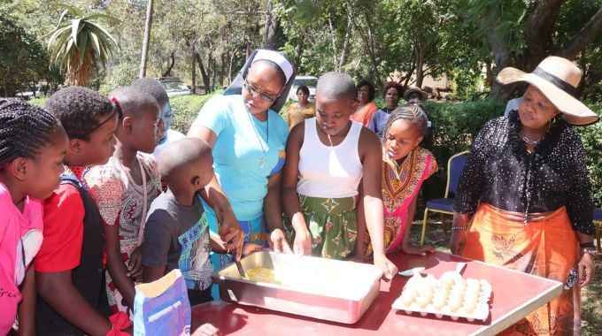 First Lady Dr Auxillia Mnangagwa teaches girls from all the country’s provinces how to bake traditional bread during their educative and interactive boot camp on Sunday