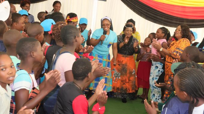 First Lady Dr Auxillia Mnangagwa joins girls from all the country’s provinces attending a weeklong boot camp sing and dance motivating each other to continue keeping themselves pure and until they finish school and attain career on Sunday morning