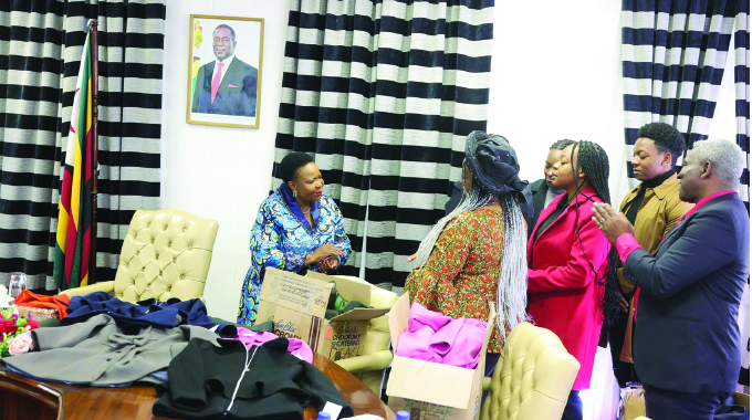 First Lady Dr Auxillia Mnangagwa thanks the Udemba family for donating an assortment of winter clothing to her Angel of Hope Foundation at Zimbabwe House yesterday