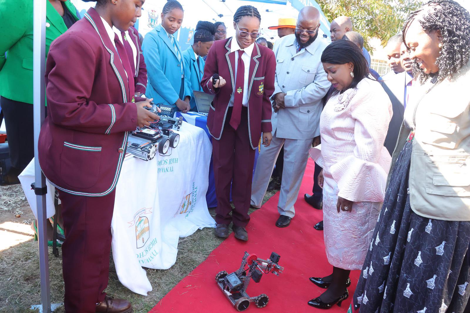 SheTech patron First Lady Dr Auxillia Mnangagwa, Minister of ICT Tatenda Mavetera and Manicaland Minister of State and Devolution Misheck Mugadza look at a robot designed by Tynwald High School learners and exhibited during the International Girls in ICT Day in Mutare yesterday. — Pictures: John Manzongo