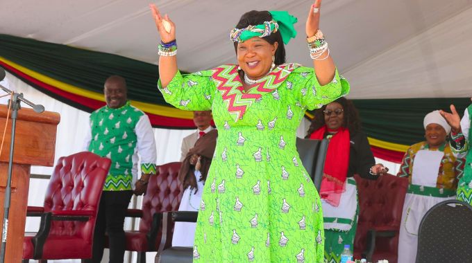 First Lady Dr Auxillia Mnangagwa showcases her national dress to thousands of people, most of whom were also clad in the national fabric a sign that the national fabric which is the brainchild of Amai Mnangagwa has been fully embraced