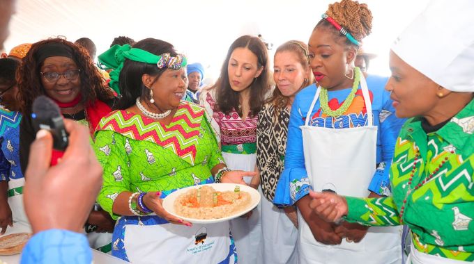 First Lady Dr Auxillia Mnangagwa shows a traditional dish designed into Great Zimbabwe monument to UN Tourism programme officer Ms Zineb Remmal, UN Tourism technical coordinator Ms Maria Soledad Gaido and Malawi Minister of Tourism Ms Vera Kamtukule, while Tourism and Hospitality Industry Minister Barbra Rwodzi and Environment and Wildlife Minister Dr Stembiso Nyoni look on during Amai’s traditional meal cookout competition in Nyanga on Africa Day.