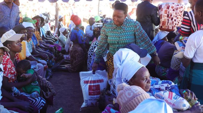 First Lady Dr Auxillia Mnangagwa distributes food hampers, blankets and other basic needs to the elderly, those living with disabilities, child headed families and other vulnerable groups in Sanya, Muzarabani about 15km from the Mozambican border yesterday.