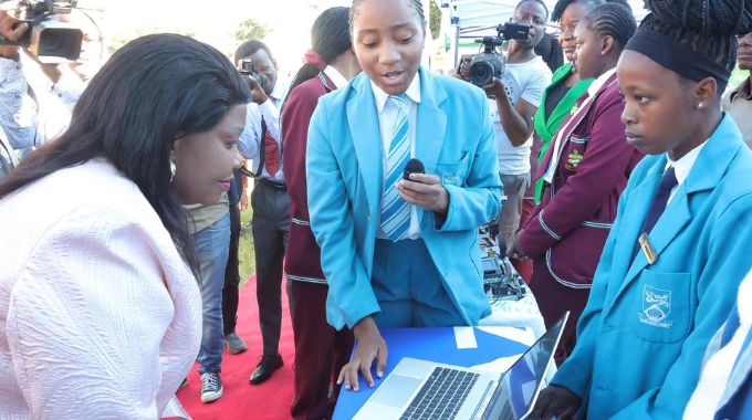 SheTech patron First Lady Dr Auxillia Mnangagwa looks at forensic software innovation by Oriel Girls High School learners at their exhibition stand during the International Girls in ICT Day in Mutare yesterday