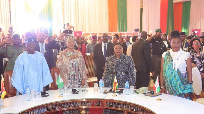 Nigerian President Bola Ahmed Tinubu, Nigerian First Lady Senator Oluremi Tinubu, First Lady Dr Auxillia Mnangagwa and First Lady Mrs Angeline Ndayishimiye Ndayubaha (Burundi) and other delegates sing the Nigerian national anthem during the launch of #We are Equal campaign in Abuja, Nigeria