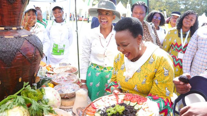 First Lady Dr Auxillia Mnangagwa looks at some of the traditional foods that include crickets during the Farm to Market and Arts festival in Harare yesterday