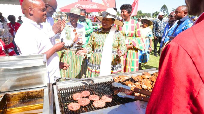 First Lady Dr Auxillia Mnangagwa, Tourism and Hospitality Industry Minister Barbara Rwodzi and other delegates listen as Spar Zimbabwe staff explain how their business was benefiting from exhibiting at the inaugural Farm to Market and Arts festival organised by Dr Mnangagwa in Harare