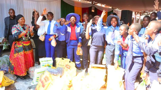 First Lady Dr Auxillia Mnangagwa reciprocates the thank you gesture in sign language from Jairos Jiri Naran schoolchildren after she gave them blankets and food hampers in Midlands province on Saturday. – Pictures: John Manzongo