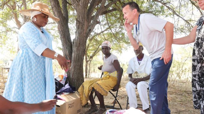 First Lady Dr Auxillia Mnangagwa and Dr Jarod Morton (who is part of the 25 doctors and humanitarian staff from the United States), look at a child who had serious burns all over her body and was being treated during the medical outreach she organised in Mashonaland East.