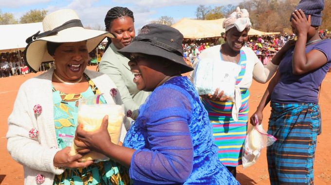 First Lady Dr Auxillia Mnangagwa shares a lighter moment with an expecting mother who could not hide her joy and excitement to receive baby preparation kits in Chingwizi