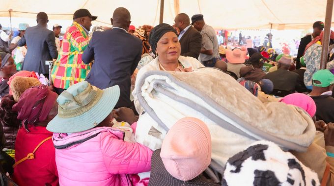 First Lady Dr Auxillia Mnangagwa hands over blankets, food hampers and other goods to the elderly, child headed families, those living with disabilities and other vulnerable groups in Chingwizi on Tuesday