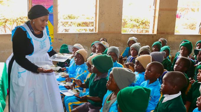 First Lady Dr Auxillia Mnangagwa serves food to learners during her school feeding programme in Epworth on Friday — Pictures: John Manzongo