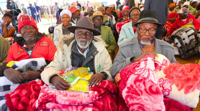 Part of the elderly, people living with disabilities, child-headed families and other vulnerable people with blankets and food hampers they received from First Lady Dr Auxillia Mnangagwa in Mashonaland West yesterday